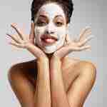 Beauty Black Woman With A Facial Mask Having Fun